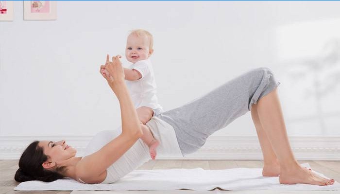 Jeune maman fait de l'exercice avec son bébé