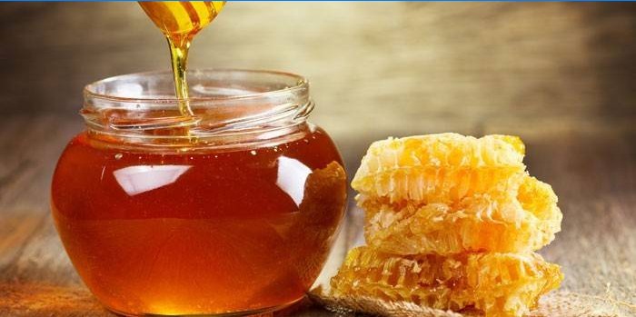 Miel en pot et nids d'abeille