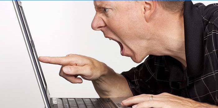 Homme en colère contre un ordinateur portable
