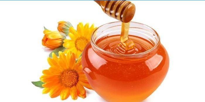 Miel en pot et fleurs