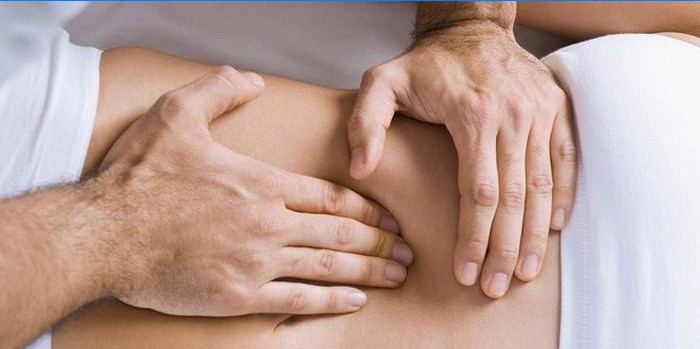 Un homme fait un massage des organes internes de l'abdomen