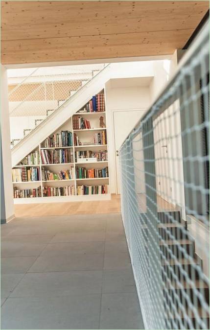 Une étagère pour les livres est intégrée dans l'escalier