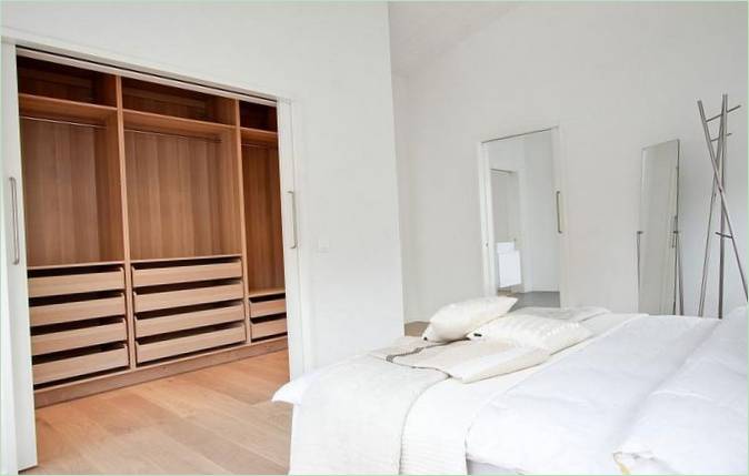 Une armoire en bois dans une chambre blanche